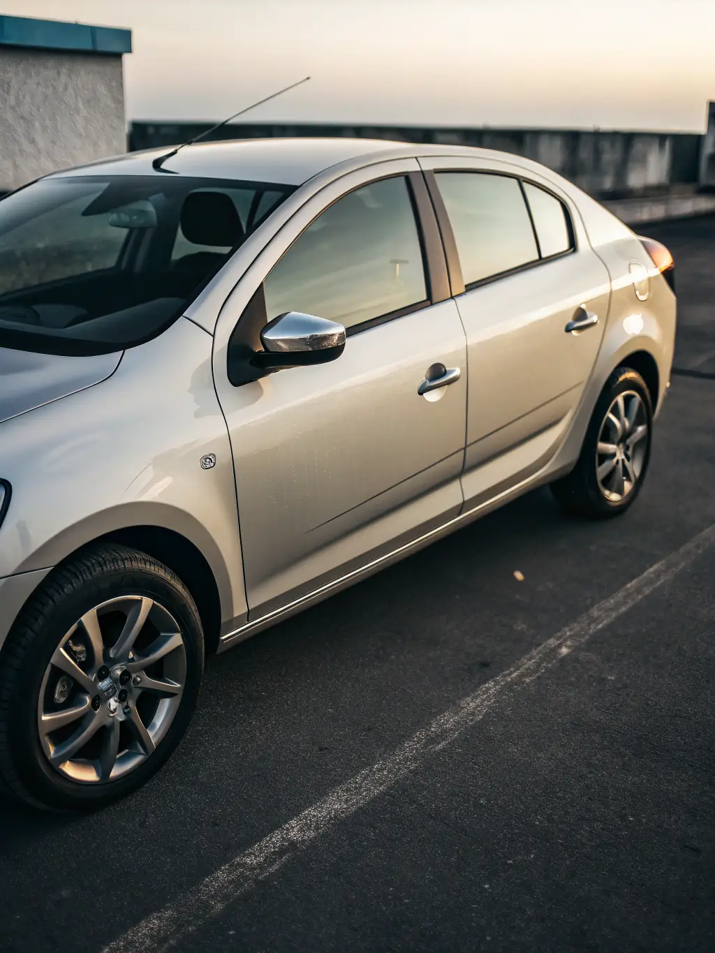 A Renault Logan car parked in a showroom, showcasing its exterior design and features, with a focus on its practicality and affordability.